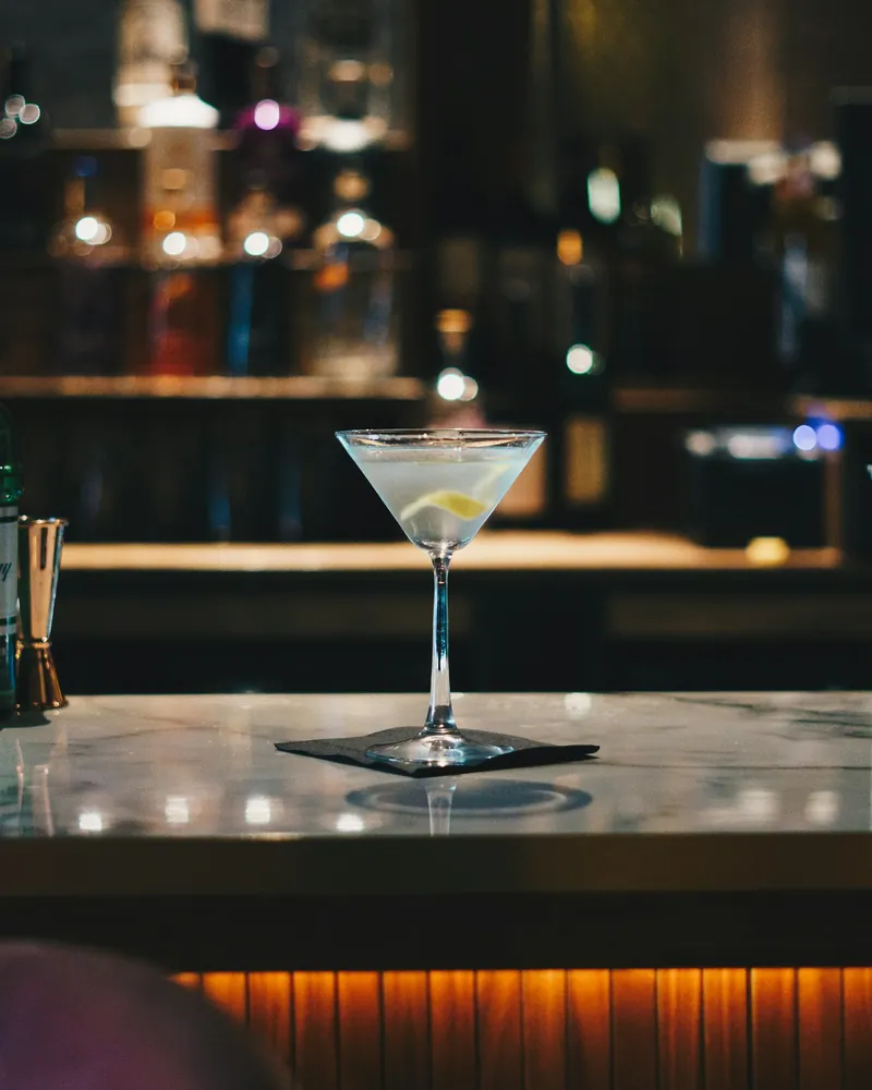 A martini on a bar at night, sample photo