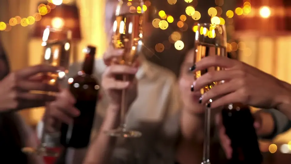 Friends clinking champagne glasses at a party, still from a sample video